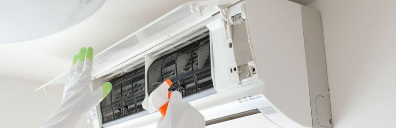 HVAC technician diagnosing air conditioning system problems