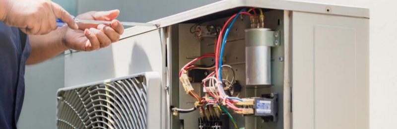 Technician inspecting furnace heating system components